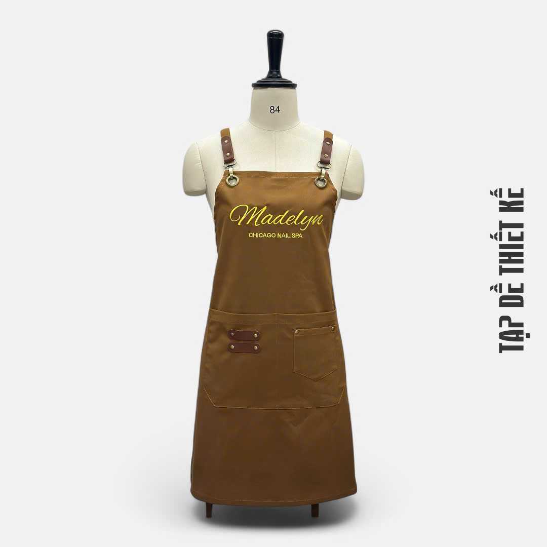 Mẫu tạp dề dây chéo sau lưng, màu be hoặc nâu cafe, tôn dáng thợ nail