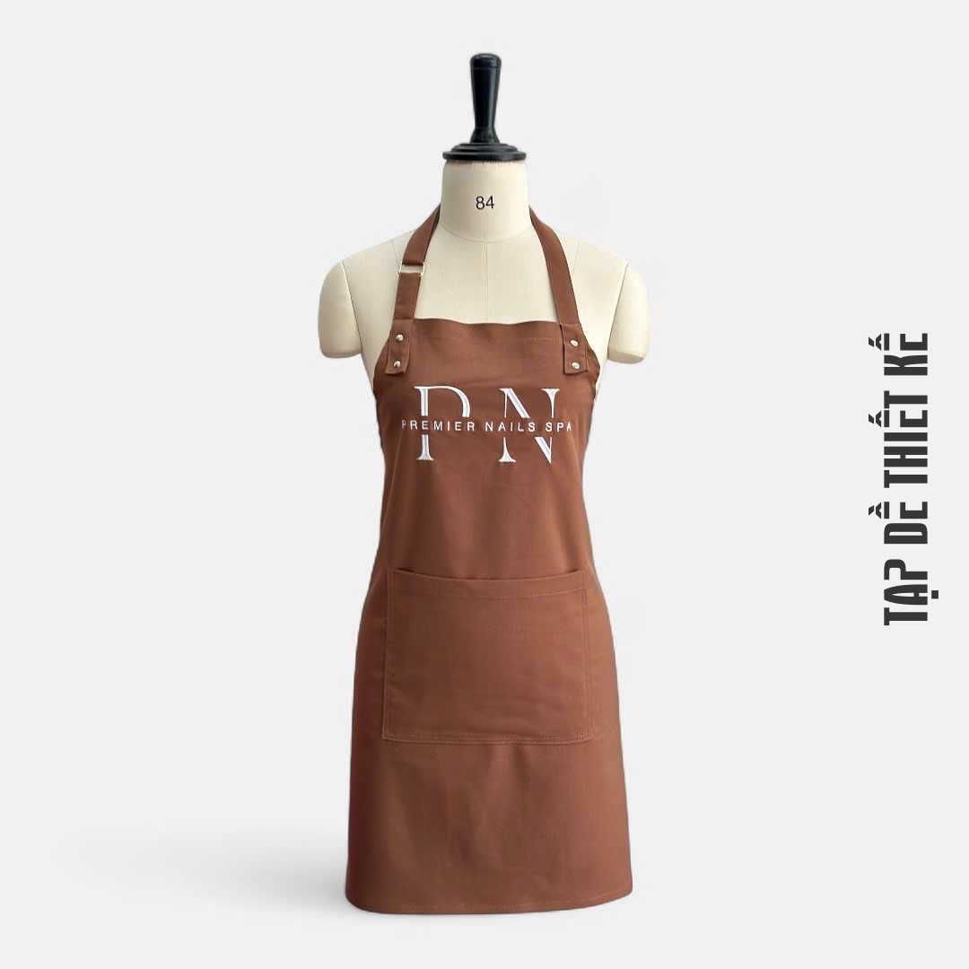 Mẫu tạp dề có nhiều ngăn túi, tiện dụng khi làm nail hoặc spa